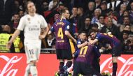 Barcelona players celebrate their opening goal during the Spanish Copa del Rey (King's Cup) semi-final second leg football match between Real Madrid and Barcelona at the Santiago Bernabeu stadium in Madrid on February 27, 2019. / AFP / OSCAR DEL POZO