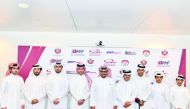 Qatar Motor and Motorcycle Federation President Abdulrahman Al Mannai (centre) poses for a group picture along with riders and drivers. 