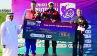 The podium winners at the Qatar Open Shotgun Championship pose for a picture with officials of Qatar Shooting and Archery Association at Losail Shooting Range yesterday