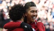 Liverpool's Brazilian midfielder Roberto Firmino (C) celebrates scoring their third goal during the English Premier League football match between Liverpool and Burnley at Anfield in Liverpool, north west England on March 10, 2019.  AFP / Paul ELLIS 
