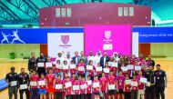 Qatar Football Association and Qatar Shell officials pose for a photograph with the award winning participants and coaches during the Koora Time Awards Ceremony held at the Aspire Dome in Doha, yesterday.