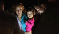 Central American asylum seekers including a Honduran girl, 2, and her mother near the US-Mexico border in McAllen, Texas on June 12, 2018. AFP / Getty Images North America / John Moore