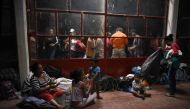 Central American migrants -taking part in a caravan called Migrant Viacrucis rest at a sports center field in Matias Romero, Oaxaca state Mexico on April 2. 2018. AFP/Victoria Razo