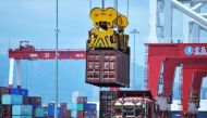 A container is transferred at a port in Qingdao, Shandong province in eastern China on July 6, 2018. AFP