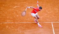 Serbia's Novak Djokovic plays a backhand return to Germany's Philipp Kohlschreiber during their tennis match on the day 4 of the Monte-Carlo ATP Masters Series tournament on April 16, 2019 in Monaco.  AFP/Valery Hache
