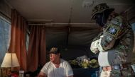 (FILES) In this file photo taken on March 20, 2019 Striker (L), the leader of the Constitutional Patriots New Mexico Border Ops Team militia, speaks with Viper (R), who go by aliases to protect their identity, inside the team's camper while discussing log