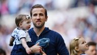 Tottenham's Harry Kane with his daughter on the pitch after the match. (REUTERS/Dylan Martinez)