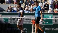 Austria's Dominic Thiem (R) celebrates after winning against Uruguay's Pablo Cuevas (L) during their men's singles third round match on day seven of The Roland Garros 2019 French Open tennis tournament in Paris on June 1, 2019. / AFP / Thomas SAMSON