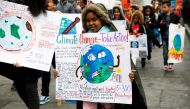 FILE PHOTO: Students hold banners and placards during a demonstration against climate change in New York, United States, March 15, 2019. REUTERS/Shannon Stapleton/File Photo