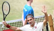 Roger Federer from Switzerland reacts after he won his match against Pierre-Hugues Herbert from France at the ATP tennis tournament in Halle, western Germany, on June 22, 2019. / AFP / CARMEN JASPERSEN