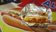A man holds out a hot dog he bought from a street vendor in Washington October 26, 2015. Reuters/Kevin Lamarque