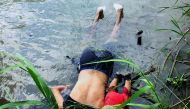 View of the bodies of Salvadoran migrant Oscar Martinez Ramirez and his daughter, who drowned while trying to cross the Rio Grande -on their way to the US- in Matamoros, state of Tamaulipas on June 24, 2019.  AFP