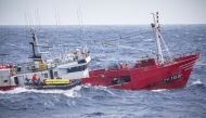 Members of Greenpeace film a Spanish fishing vessel capturing sharks near the Portuguese Azores, Portugal June 26, 2019. Greenpeace/Handout via Reuters
