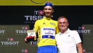 France's Julian Alaphilippe (L) poses with former French champion Bernard Hinault as he celebrates his overall leader's yellow jersey on the podium of the thirteenth stage of the 106th edition of the Tour de France cycling race, a 27,2-kilometer individua