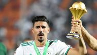 Algeria's Baghdad Bounedjah celebrates with the trophy after winning the Africa Cup of Nations (REUTERS/Suhaib Salem)