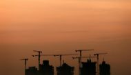 Cranes stand above an apartment complex under construction in Singapore, May 15, 2013. Reuters / Tim Wimborne