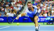 Stan Wawrinka of Switzerland reaches for the ball from Novak Djokovic of Serbia in their Round Four Men's Singles tennis match during the 2019 US Open at the USTA Billie Jean King National Tennis Center in New York on September 1, 2019. AFP / Dominick Reu