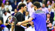 Roger Federer of Switzerland, left, and Grigor Dimitrov of Bulgaria shake hands after Dimitrov wins the quarterfinal match on day nine of the 2019 US Open tennis tournament at USTA Billie Jean King National Tennis Center. Credit: Danielle Parhizkaran-USA 