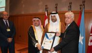 Sheikh Dr Thani bin Ali Al Thani (second right), receiving ‘international ambassador for social responsibility’ title during the event.