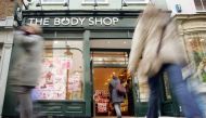 Shoppers walk into a Body Shop store in Covent Garden, central London, March 17, 2006.