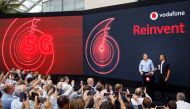 Vodafone UK CEO Nick Jeffery and Formula One racing car driver Lewis Hamilton attend the launch of Vodafone UK 5G mobile data network in London on July 3, 2019. AFP / Tolga Akmen