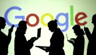 Silhouettes of laptop and mobile device users are seen next to a screen projection of Google logo in this picture illustration taken March 28, 2018. Reuters / Dado Ruvic