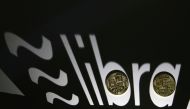Shadow of a 3D-printed Facebook Libra cryptocurrency logo is seen near cryptocurrency representation in this illustration taken, September 13, 2019. REUTERS/Dado Ruvic/File Photo
