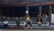 This photograph taken on October 6, 2019 shows an elderly man playing croquet in a courtyard in Hanoi's Soc Son district. AFP / Manan VATSYAYANA