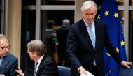 European Union's chief Brexit negotiator Michel Barnier (R) arrives for a meeting at the European Parliament in Brussels, on October 16, 2019. / AFP / Kenzo TRIBOUILLARD