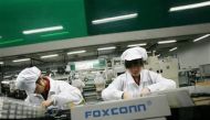 Employees work inside a Foxconn factory in the township of Longhua in the southern Guangdong province in this May 26, 2010 file photo. Reuters/Bobby Yip