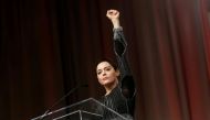 FILE PHOTO: Actor Rose McGowan raises her fist after addressing the audience during the opening session of the three-day Women's Convention at Cobo Center in Detroit, Michigan, U.S., October 27, 2017. REUTERS/Rebecca Cook/File Photo
