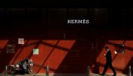 A man walks past a store of luxury goods retailer Hermes one day before the opening session of the National People's Congress (NPC) in Beijing, China March 4, 2019. Reuters/Thomas Peter