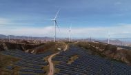 Wind turbines and solar panels are seen at a wind and solar power plant in China, October 29, 2018. Reuters