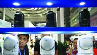 A visitor looks at surveillance cameras at the 17th China Public Security Expo at the Shenzhen Convention and Exhibition Center on October 28, 2019. AFP / Noel Celis