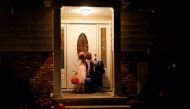  Children wait at a doorway as they go 