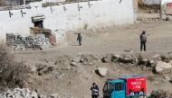  A delivery man of Alibaba's logistics unit Cainiao talks on a phone as he delivers a parcel in Lhasa, Tibet Autonomous Region, China January 13, 2018. Reuters