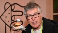 Impossible Foods CEO Pat Brown holds up an Impossible Burger 2.0, the improved version of plant-based vegan burger that tastes real beef at a press event during CES 2019 in Las Vegas on January 7, 2019. AFP / Robyn Beck