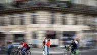 In this file photo taken on September 13, 2019 a couple rides an electric scooter in Paris. (AFP / Martin Bureau) 