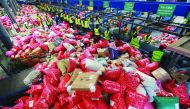 This photo taken on November 11, 2019 shows workers sorting out packages at a delivery company warehouse on 
