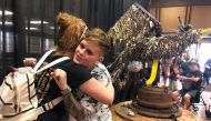 Artist Jessie Mercer gives a resident of wildfire-hit Paradise, California, a hug near her sculpture Key Phoenix, made with keys from thousands of homes and buildings lost in the November 2018 blaze, Nov. 8, 2019. Thomson Reuters Foundation/Ellen Wulfhors