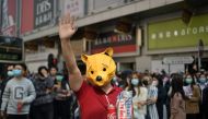 A man wears a “Winnie the Pooh“ mask as he joins others in a lunchtime flash mob rally in the Cheung Sha Wan district in Hong Kong on November 29, 2019. AFP / Philip Fong
 