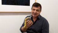 David Datuna shows the remains of the artwork 'Comedian' by the artist Maurizio Cattelan at Perrotin stand in Art Basel in Miami Beach, Florida, December 7, 2019. REUTERS/Eva Marie Uzcategui