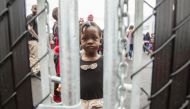 A girl who crossed the Canada-US border with her family claiming refugee status in Canada at a temporary detention centre in Blackpool, Quebec, on August 5, 2017. AFP / Geoff Robins