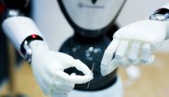 A CloudMinds robot uses a needle at the Mobile World Congress in Barcelona on February 26, 2019. AFP / Pau Barrena
