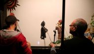Members of Egypt's Wamda troupe manipulate puppets during a Aragoz puppets show in Beit al-Sehemi, in Cairo's Gamaliya district, on November 15, 2019.  AFP / Mohamed el-Shahed 
