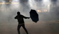 An anti-government demonstrator reacts amid tear gas during protests at Tsim Sha Tsui, in Hong Kong, China, November 18, 2019. Reuters / Athit Perawongmetha