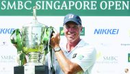 Matt Kuchar of the US poses with the trophy after winning the Singapore Open tournament at Sentosa golf club in Singapore on January 19, 2020. AFP / Roslan Rahman
