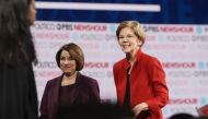 (FILES) In this file photo taken on December 19, 2019, Democratic presidential candidate Senator Elizabeth Warren (D-MA) (R) and Senator Amy Klobuchar (D-MN)) walk on the stage after the Democratic presidential primary debate at Loyola Marymount Universit