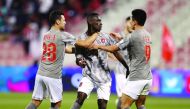 Almoez Ali (centre) celebrates with team-mates after scoring a goal against Al Arabi yesterday.
