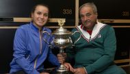 This hand out picture supplied by the Australian Open shows Sofia Kenin of the US and her father Alex pose with the trophy in locker room after winning against Spain's Garbine Muguruza in the women's singles final match on day thirteen of the Australian O